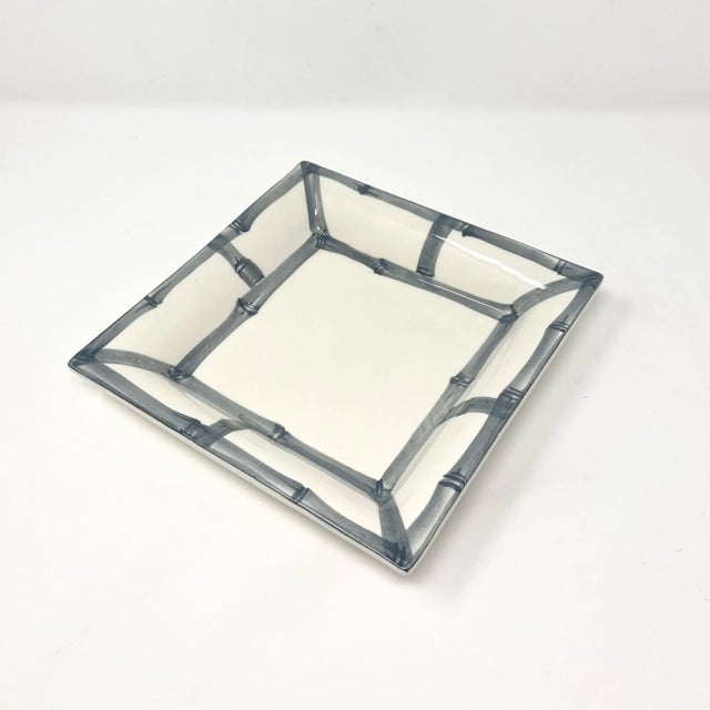 Elevate your everyday with this versatile square catchall tray, framed in a classic bamboo fret motif. Handcrafted in...