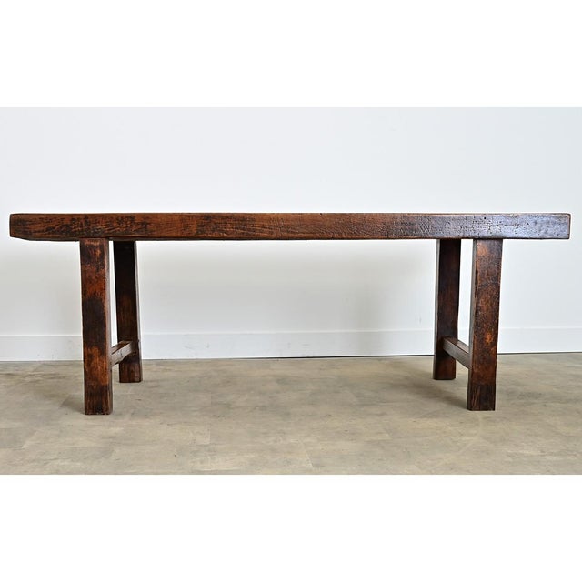 A muscular French beech wood farm table from circa 1870 of thick proportions to anchor a dining room or workspace. The...