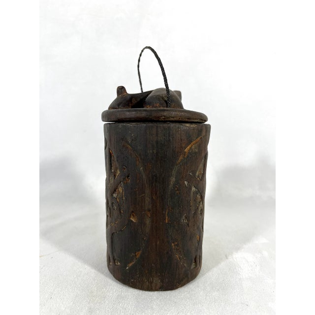 Old South East Asian primitive tribal wood storage box. This hand carved piece is lidded and most likely originated from...