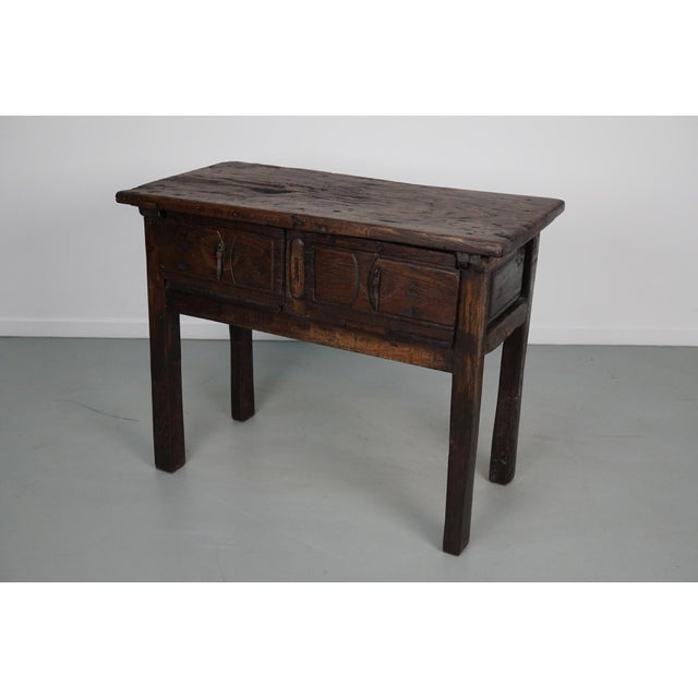 This elegant table was made in Spain from chestnut with beautiful grain patterns. It has a warm color with many marks of...