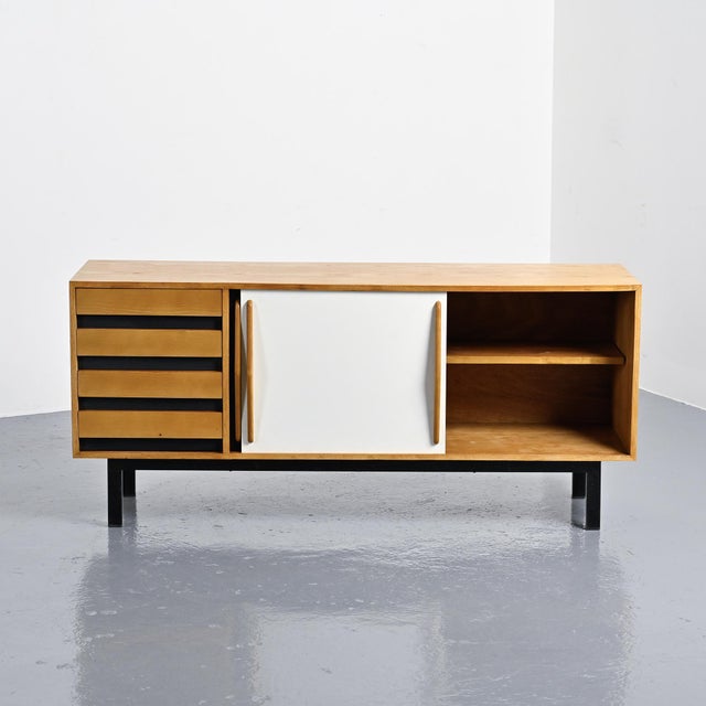 Cansado sideboard with an ash veneer body, opening with two sliding doors covered in black and white laminate and four...