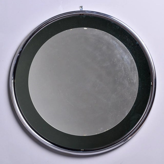 Circa 1960s mirror attributed to Italian maker Cristal Arte features a round, floating style chrome frame and smoke...