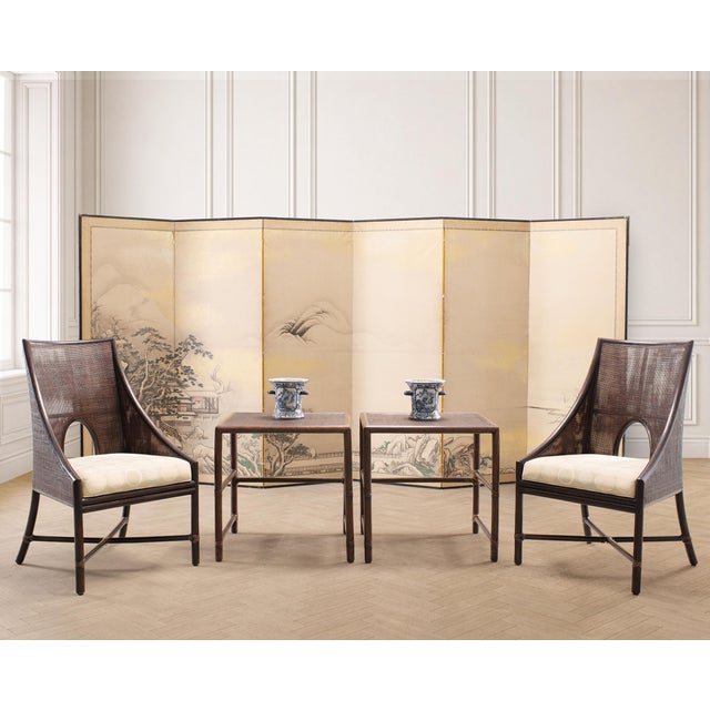 A stylish and iconic pair of rattan and cane dining armchairs designed by Barbara Barry for McGuire, San Francisco, CA....