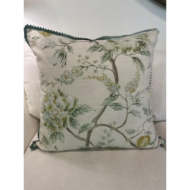 a beautifully tailored linen pillow featuring an elegant botanical print of painterly florals, leafy branches, and subtle...