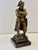 Antique cast bronze sculpture depicting French Emperor Napoleon Bonaparte standing in his iconic crossed-arms pose,...