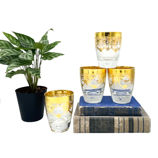 A beautiful set of four Italian lowball glasses by Cre Art, featuring richly gilded rims and an elegant neoclassical swag...