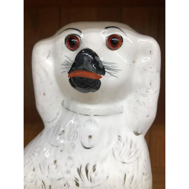 A pair of antique white Staffordshire porcelain facing spaniels. Set 2 dogs Statue glass eyes with gold gilt. Approximate...