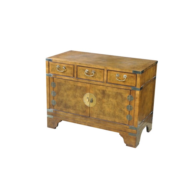 This authentic Baker Furniture campaign-style chest or nightstand (Model Number 1428 40) is a striking example of the mid...