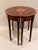 Classic pair of flame mahogany demilune consoles having beautiful inlay detail and fan decoration.
