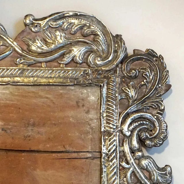This unusual antique, Indian frame was hand fashioned with repousse silver applied over a teakwood base. Displaying the...