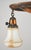 Early 20th century Victorian semi flush mount ceiling light with two white and tan shades suspended downward from a...