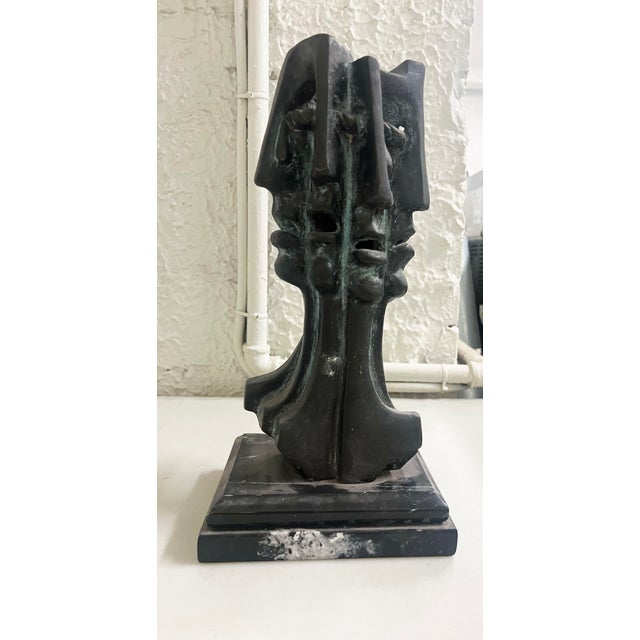 Dramatic Brutalist style bronze Faces, by artist Eduardo Montiel, Mexican, 20th century. Bronze on a black marble base....