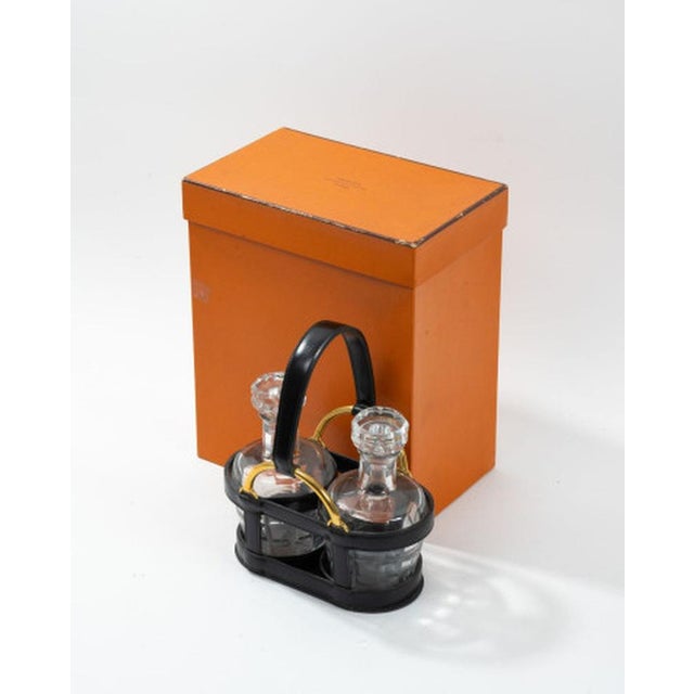 Liqueur cabinet comprising two Baccarat cut crystal decanters with their stoppers, and a black box leather bottle rack...