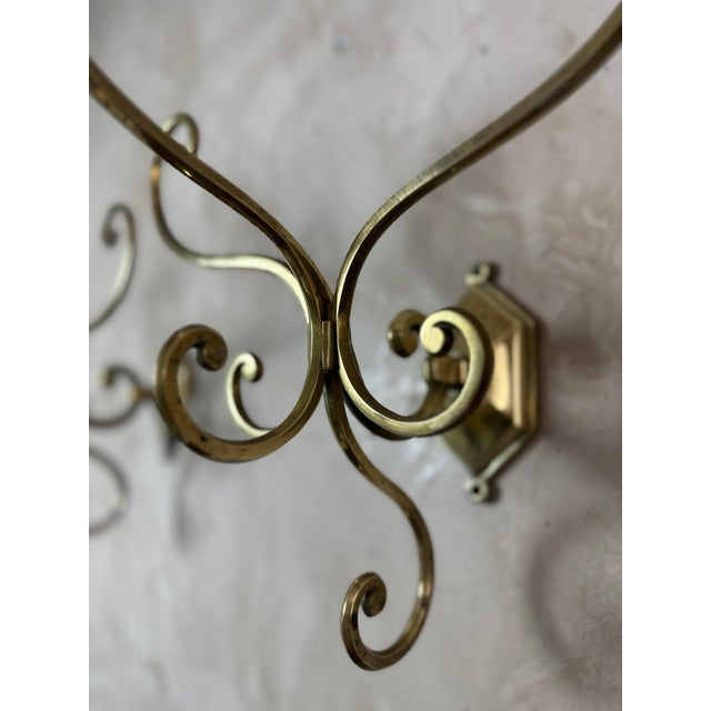An elegant pair of solid brass coat hooks dating from around 1900. Their curved design makes them true decorative pieces...