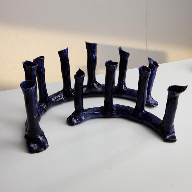The Indigo Blue Ceramic Candle Holder Set is a stunning testament to exquisite craftsmanship, ideal for those with refined...
