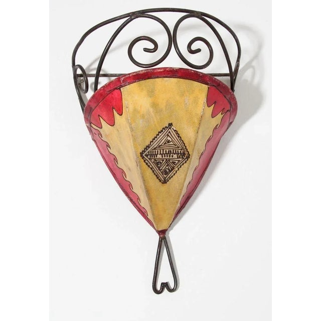 African Tribal Art parchment wall shade sconce featuring a large curved hide form stitched on iron and hand painted...