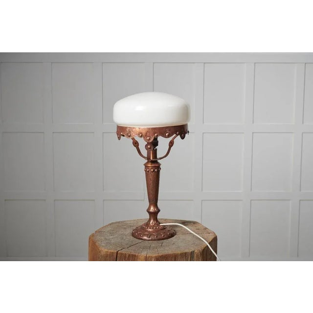 Swedish art nouveau light from the 1920s. The table light has a base made by hand in solid brass with decor. The shade is...