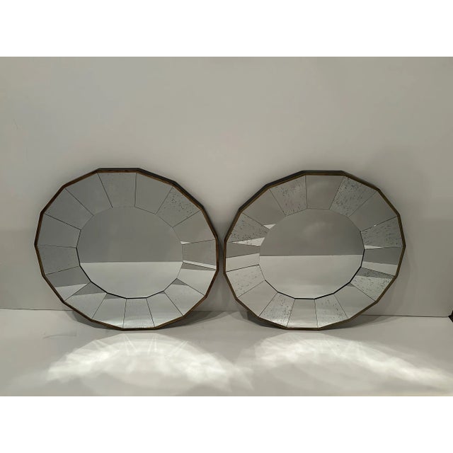 Cool Mid-Century Modern scalloped mirror with a starburst design consisting of aged mirror set in a dark frame highlighted...