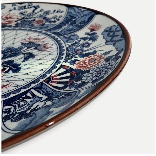 A striking Toyo Japan Imari porcelain charger featuring rich cobalt blue, iron red, shimmering gilt accents, and an...