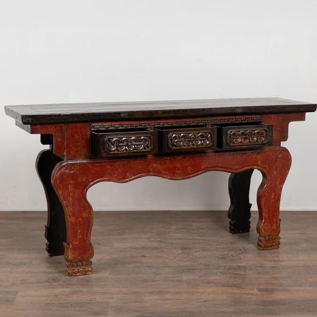 19th century Chinese altar console table crafted in elm. The table features three drawers with high relief carved...