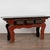 19th century Chinese altar console table crafted in elm. The table features three drawers with high relief carved...