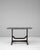 An authentic industrial table combining wrought iron framing with a durable stone top, reflecting workshop and factory...