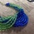 The necklace by Coppola e Toppo features a dramatic interplay of cobalt blue and light green crystal beads, arranged in a...