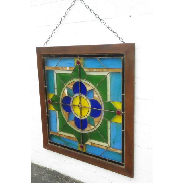 This beautiful suncatcher is made out of glass with a wood frame. This large suncatcher has a gorgeous stained glass...