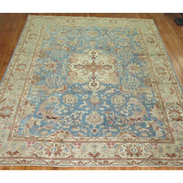 An early 20th century room size Persian Tabriz Formal rug. A sky blue field , ivory border with predominant accents in...
