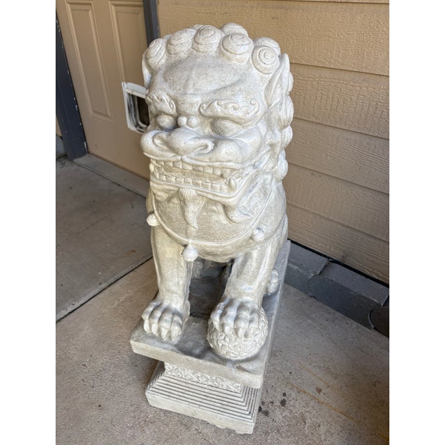 A striking and monumental pair of vintage mid-to-late 20th-century Chinese Foo Dog guardian lions, masterfully cast in...