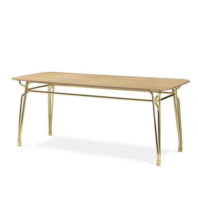 Class and simplicity characterize the Botany Table with a structure in polished brass and top crafted in wood. The chic...