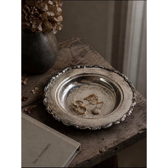 A handsome Oneida USA silver plate serving bowl featuring a boldly cast Rococo-style scrollwork border — continuous waves...