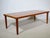 Coffee table by Grete Jalk for Glostrup from the 1960s, featuring a rectangular teak tabletop, softly rounded edges, and...