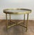 This magnificent neoclassical-style round coffee table is made of brass with faux-antique mirrors. It is a French work by...