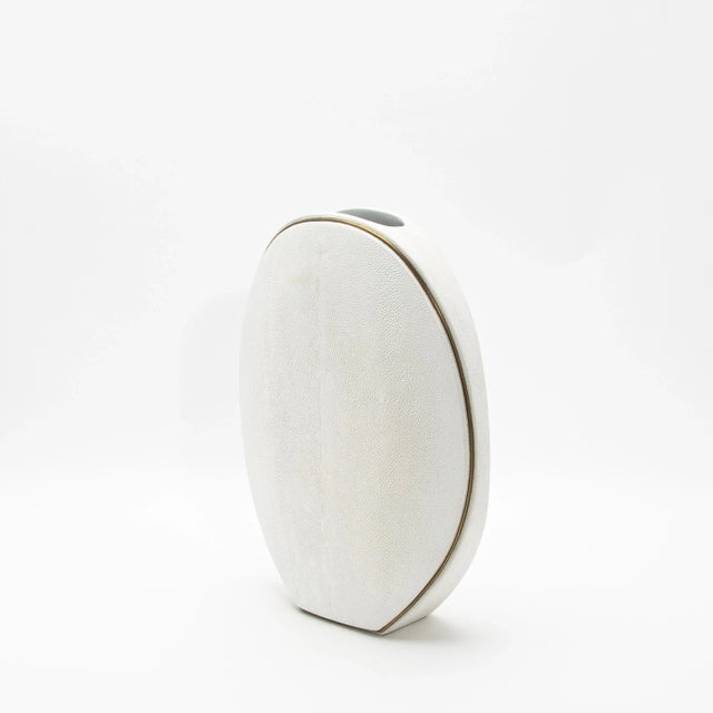 The elegant Oval Vase by R&Y Augousti, crafted in shagreen and accented with brass, is a sophisticated fusion of organic...