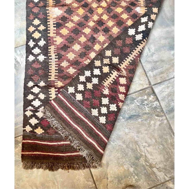 A stunning vintage Kilim runner in the style of Anatolian tribal rugs, entirely hand-woven on a flat loom around the...
