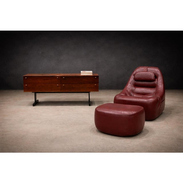 A rare and exceptionally preserved MP-113 lounge chair with matching ottoman by Percival Lafer, produced in Brazil during...