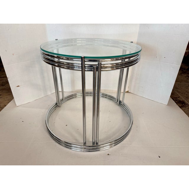 Sleek, sculptural, and effortlessly chic, this Milo Baughman chrome and glass end table brings iconic mid-century glamour...