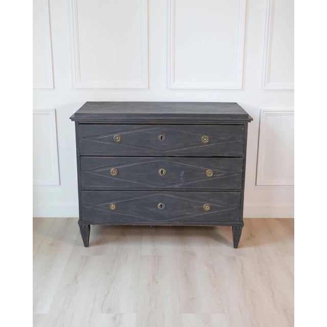 A refined Swedish chest of drawers from circa 1840, distinguished by its elegant simplicity and beautifully carved diamond...