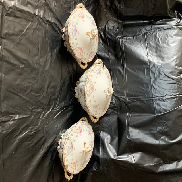 Here is a set of antique Haviland Limoges serving dishes with lids. They feature a delicate floral design in pink, yellow...