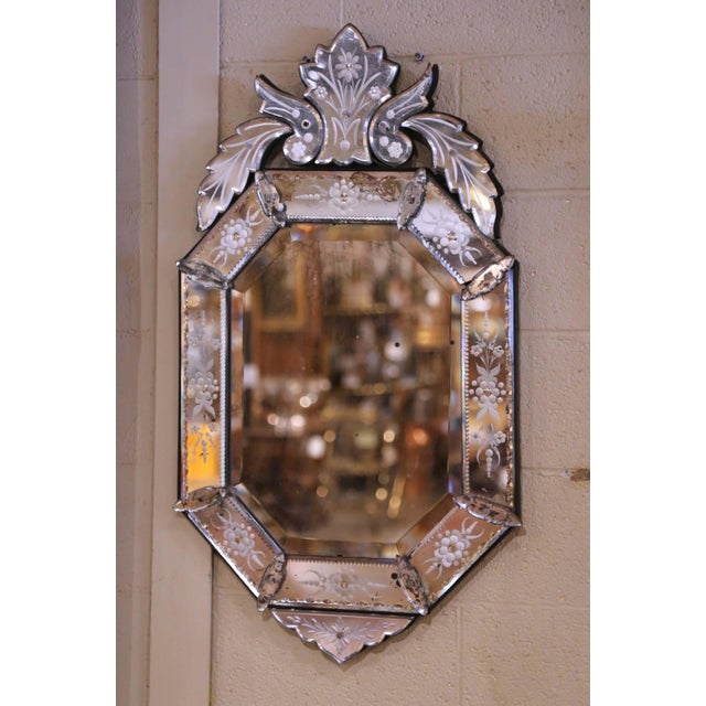 This elegant antique Venetian wall mirror, crafted in Italy circa 1920, features a refined octagonal form surrounded by...
