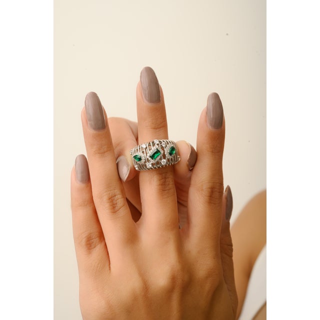 This Bochic wide band ring is crafted from high-quality 925 sterling silver and features vibrant green cubic zirconia in a...