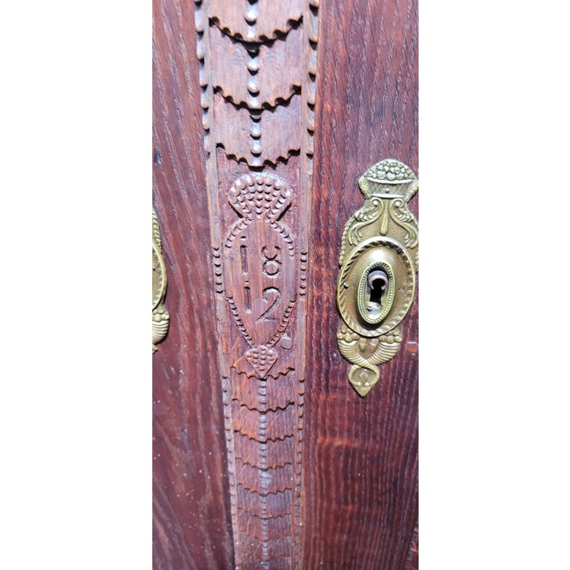 A Baroque Renaissance oak carved Armoire from 1812. Heavy Oak breaks down for shipping. All peg construction. Sea Serpent...