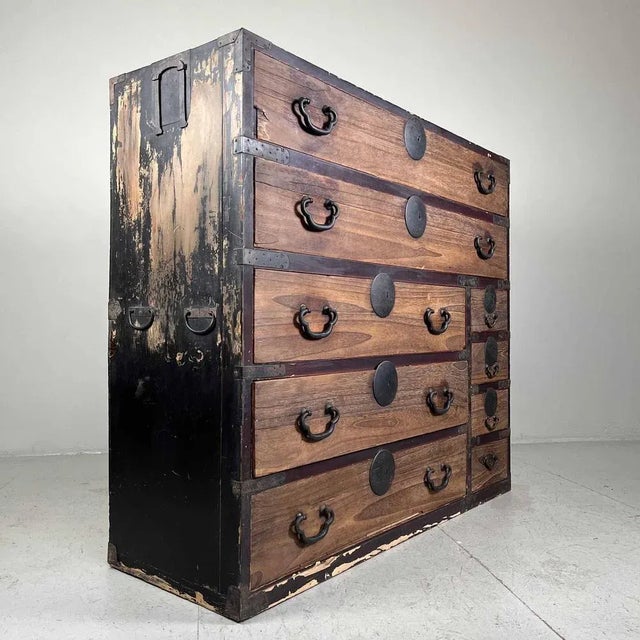 Gorgeous, weathered Japanese Kimono chest of drawers from the Taishō period (1912-1926). This chest features nine drawers,...
