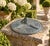 A classic vintage iron verdigris garden sundial inspired by traditional English estate landscapes, reading "Grow old along...