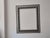 3.75" wide wood frame, not attached to painting, ( but painting fits). Raised, elegant embossing on silver and black wood...