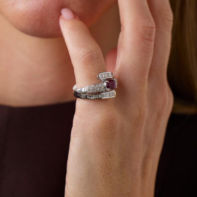 This elegant vintage ruby and diamond bypass ring is a beautifully sculptural design from the 2000’s, centered by an oval...
