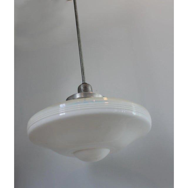 This gorgeous Art Deco Flying Saucer light has the original hardware. Removed from an N.Y.C. brownstone, this piece dates...