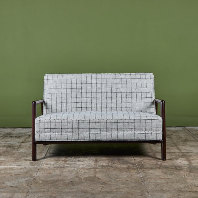 Loveseat by T.H Robsjohn Gibbings, for Widdicomb c.1950s USA. This sofa features rounded stained beech wood frame with...