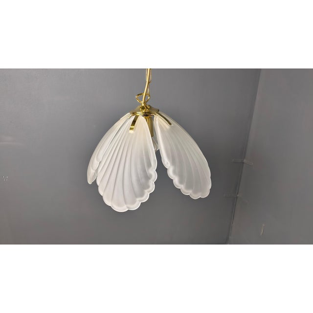 Stunning italian glass chandelier with a brass frame. The chandelier has glass art deco style frosted shades. Tested and...